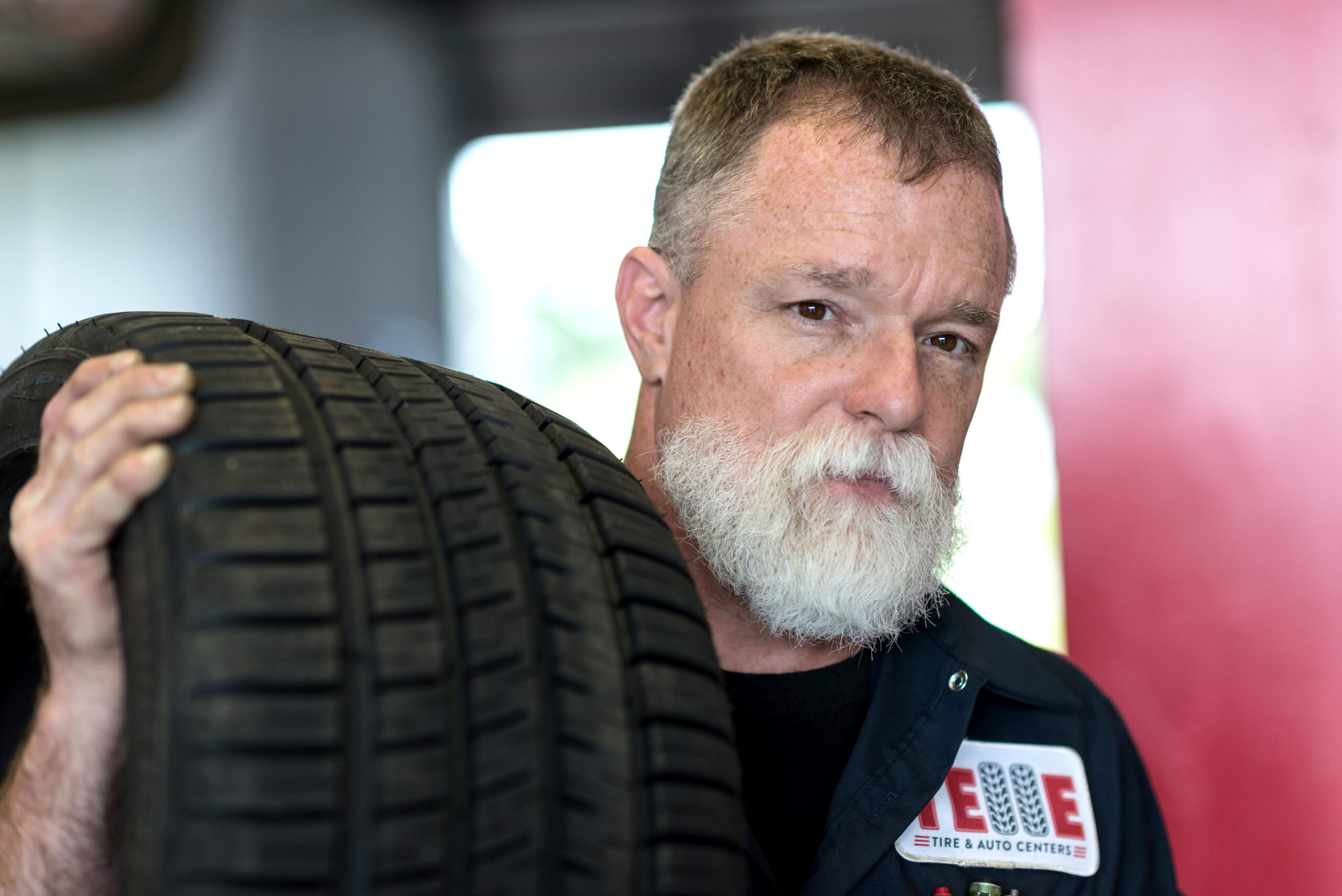 sean with tire Telle Tire mechanic with tire